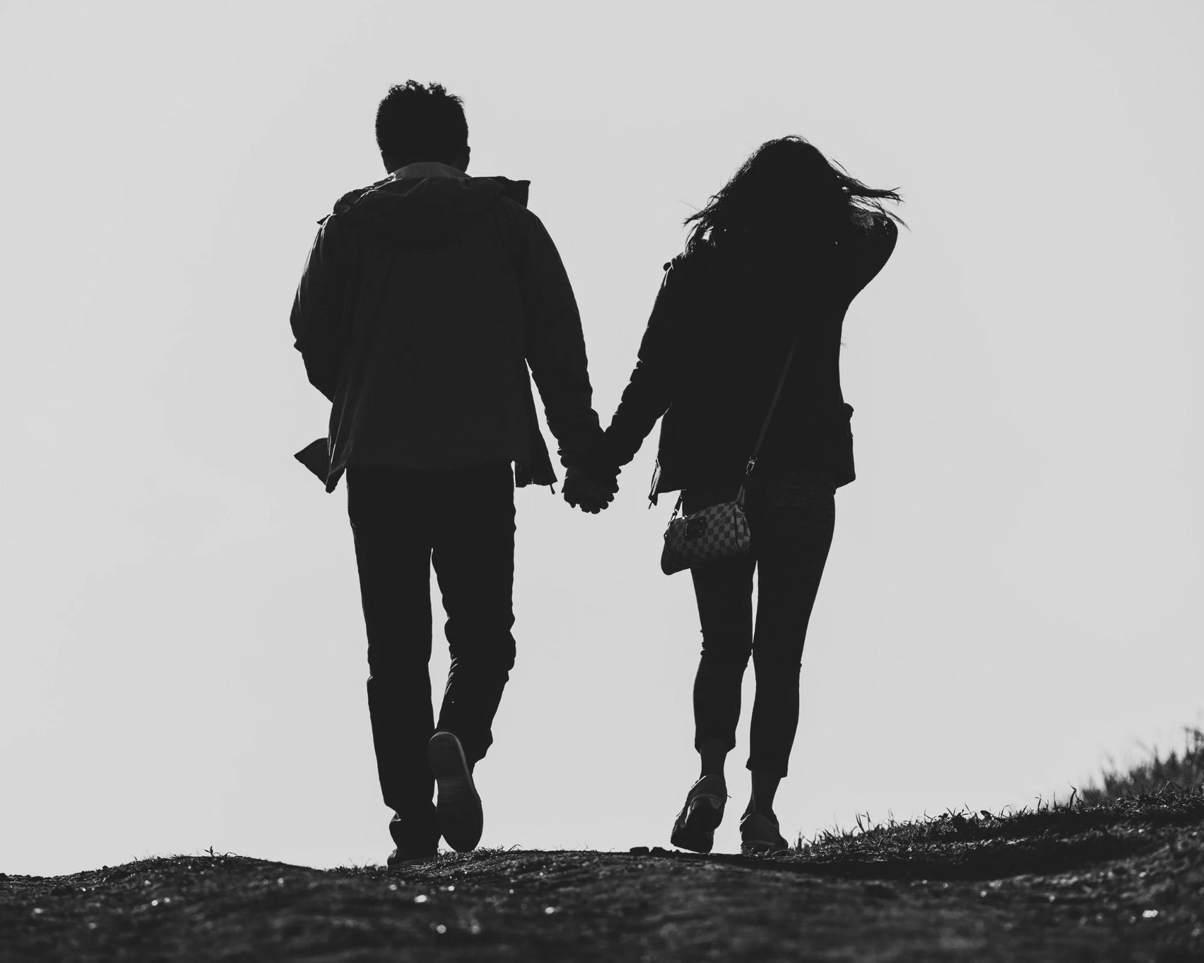 A couple walking together, seen from behind