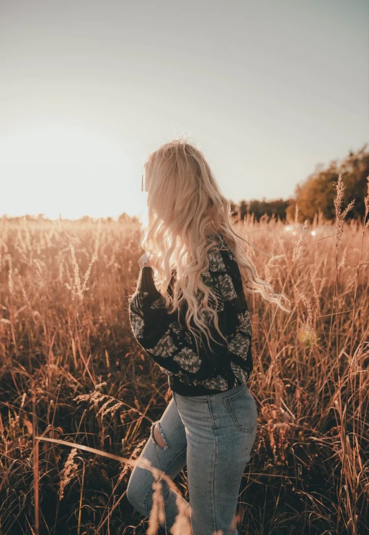A woman standing in a golden field